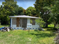 Image of a boarded up home