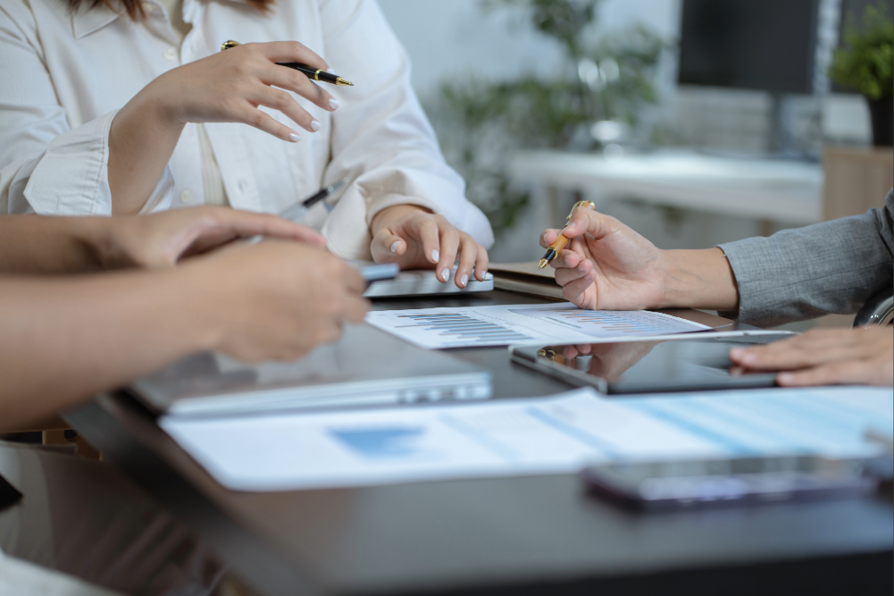 Medical professionals planning around a table.