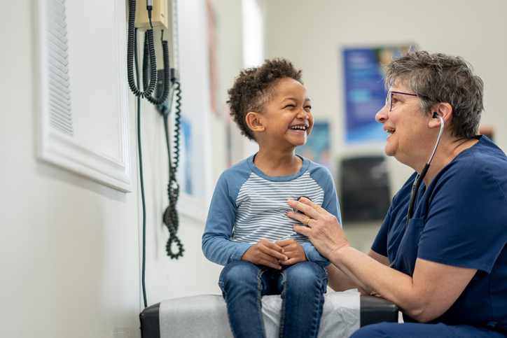 Health care professional speaking with a child